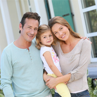 Smiling parents with their toddler daughter