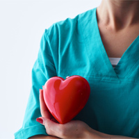 Female Nurse holding a heart shaped object